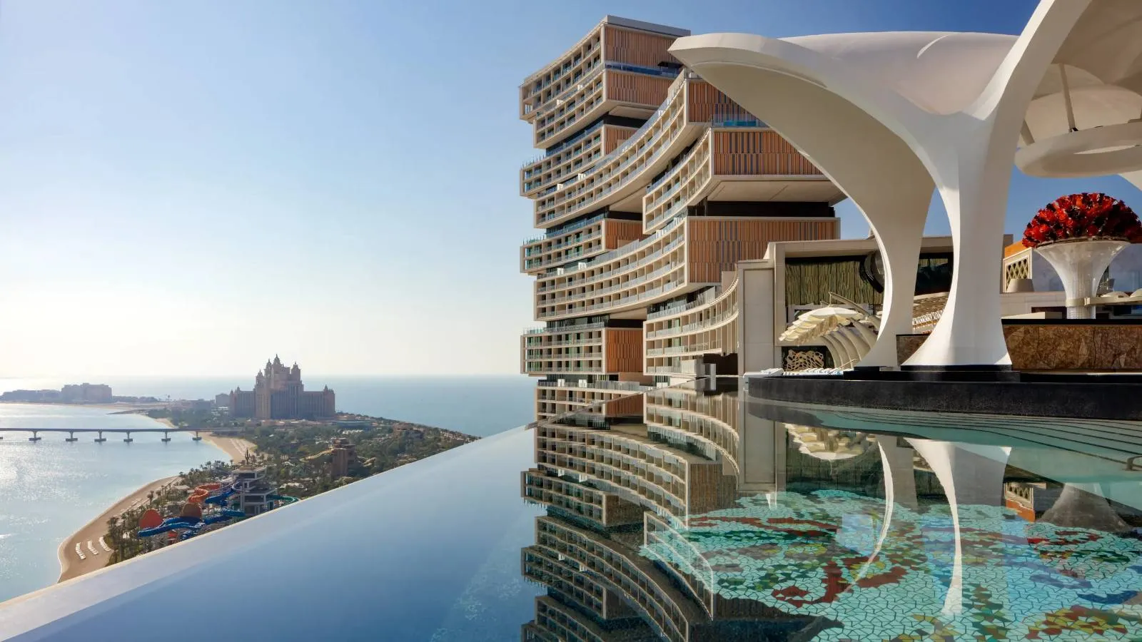 An infinity pool above the water at dusk
